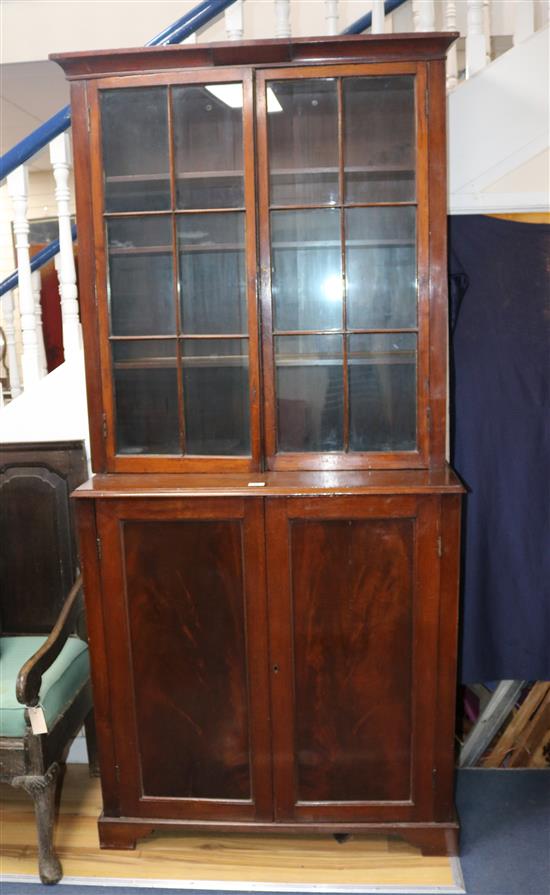 A 19th century mahogany cupboard, with associated glazed two door top, W.101cm